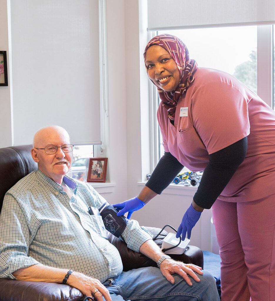 nurse checking blood pressure for resident