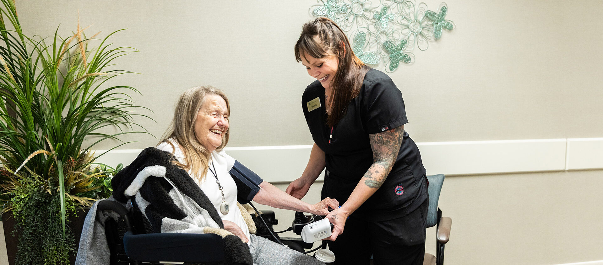 nurse helping resident laughing e1786402677541