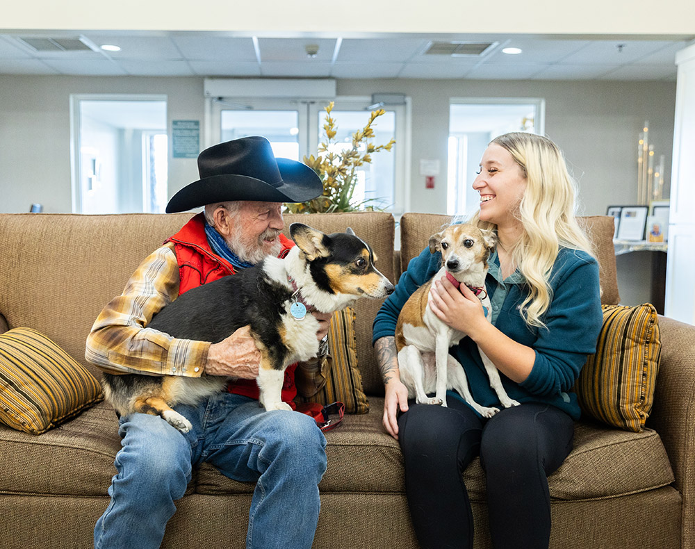 resident and staff playing with dogs