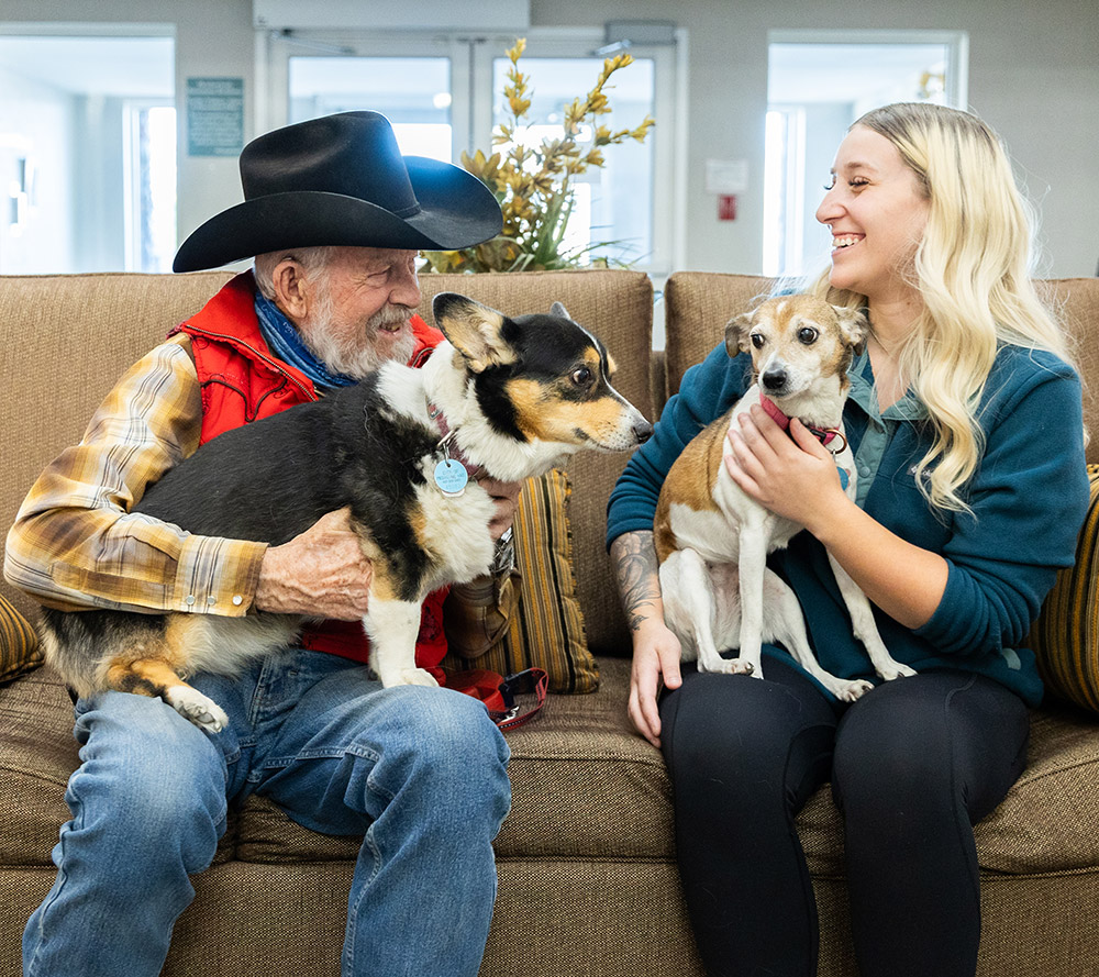 resident and staff with two dogs