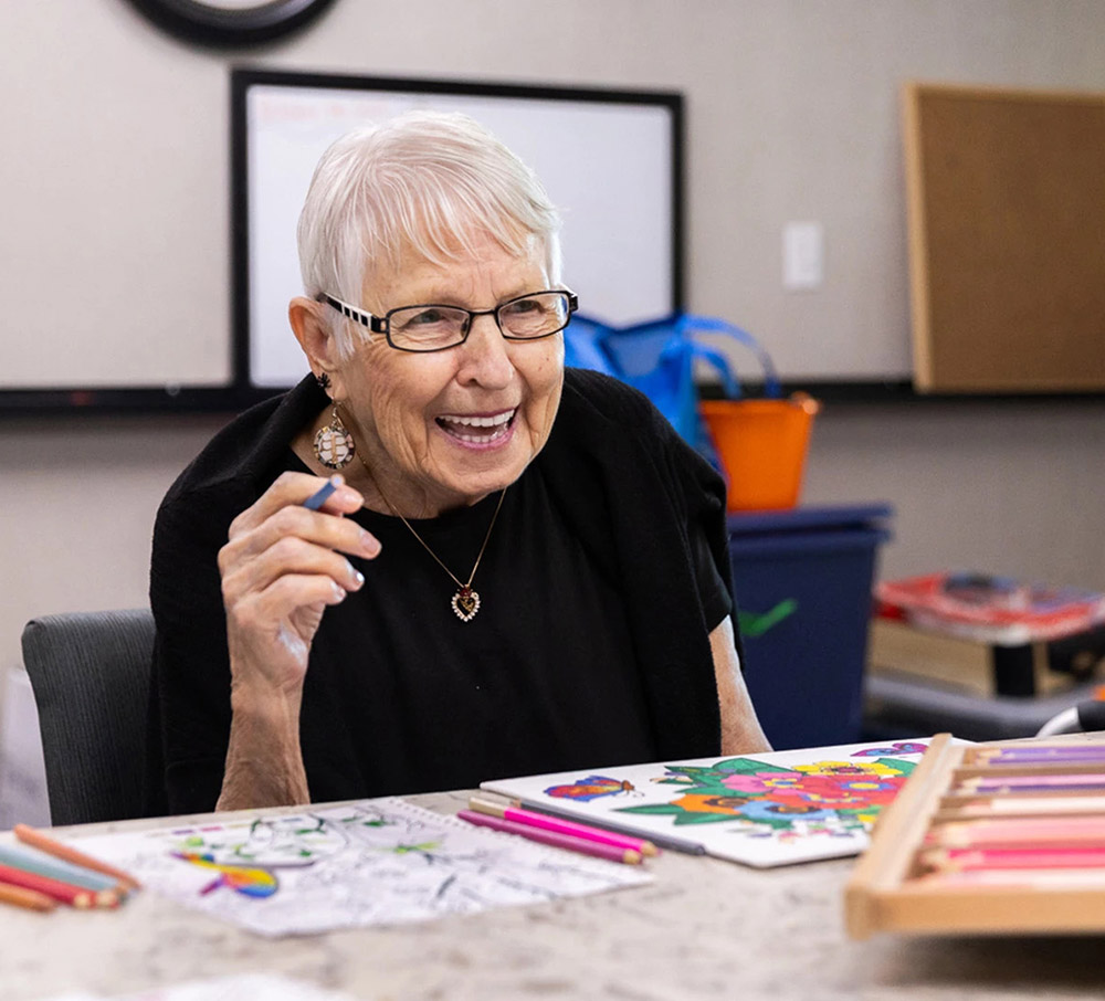 resident laughing while colouring