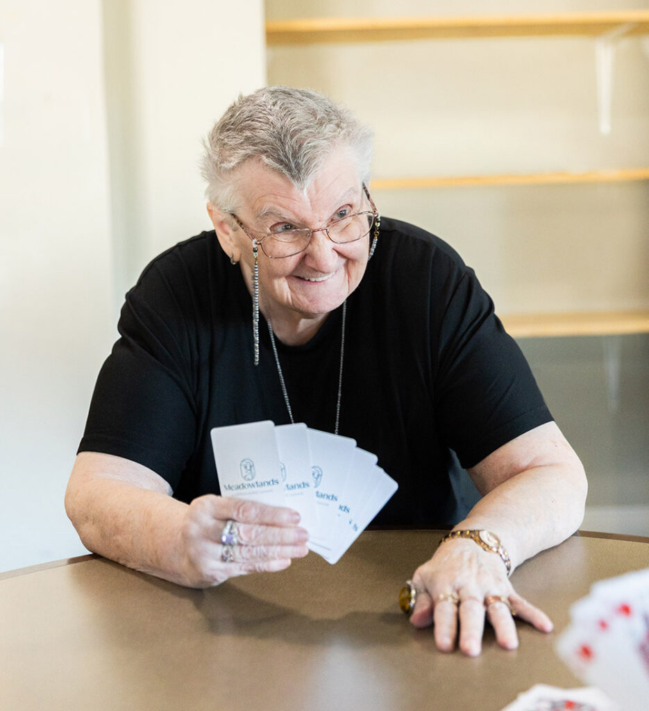 resident with glasses playing cards