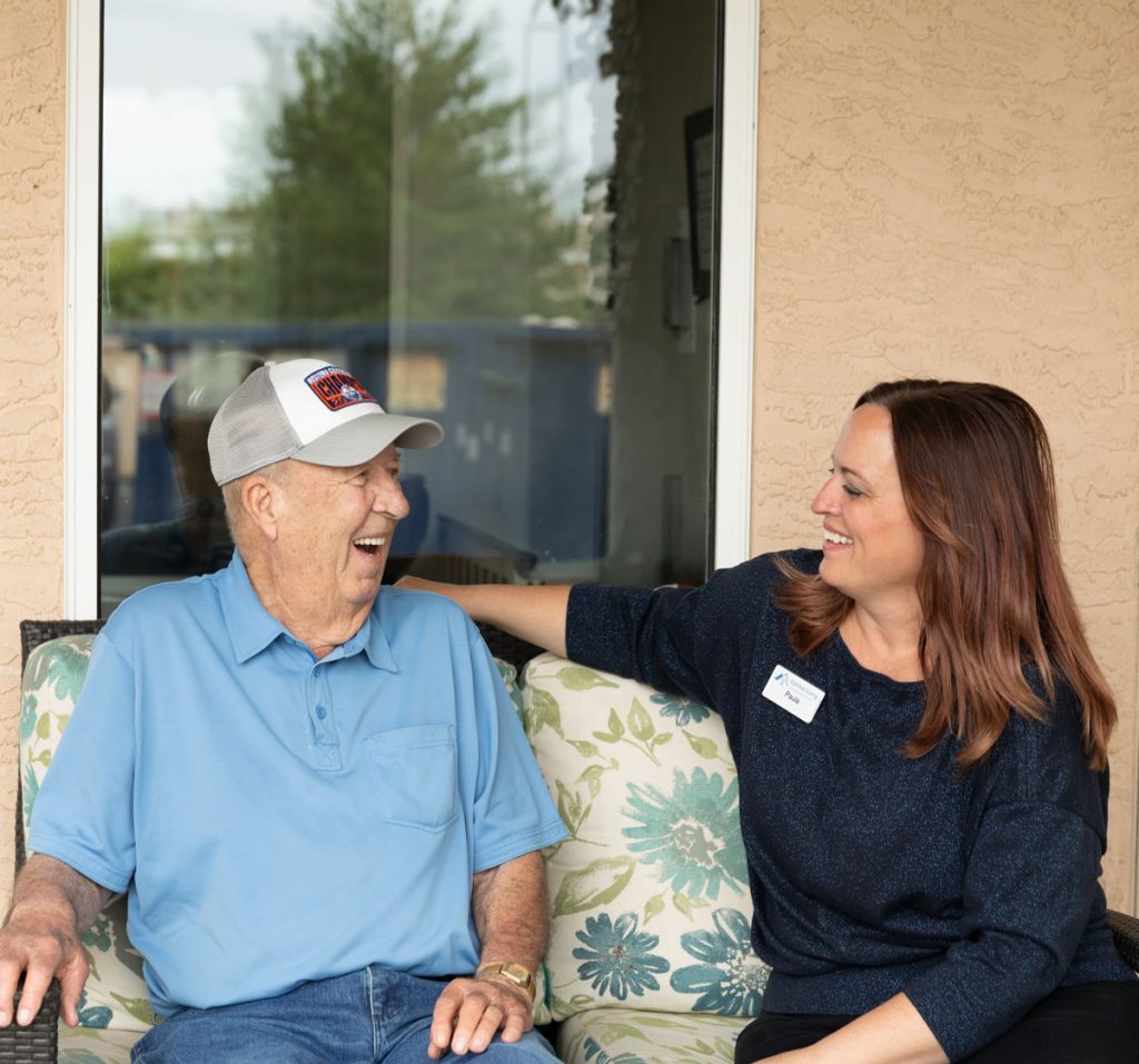 smiling resident and team member sitting