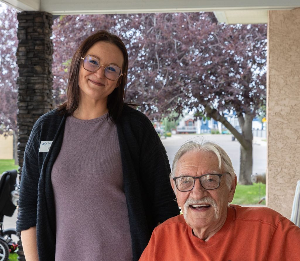 smiling team member and resident outside
